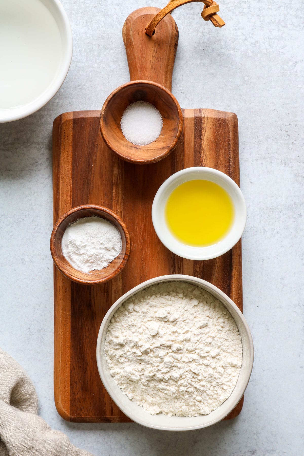 Easy Skillet Flatbread ingredients: flour, baking powder, olive oil, salt, and non-dairy milk (or water).