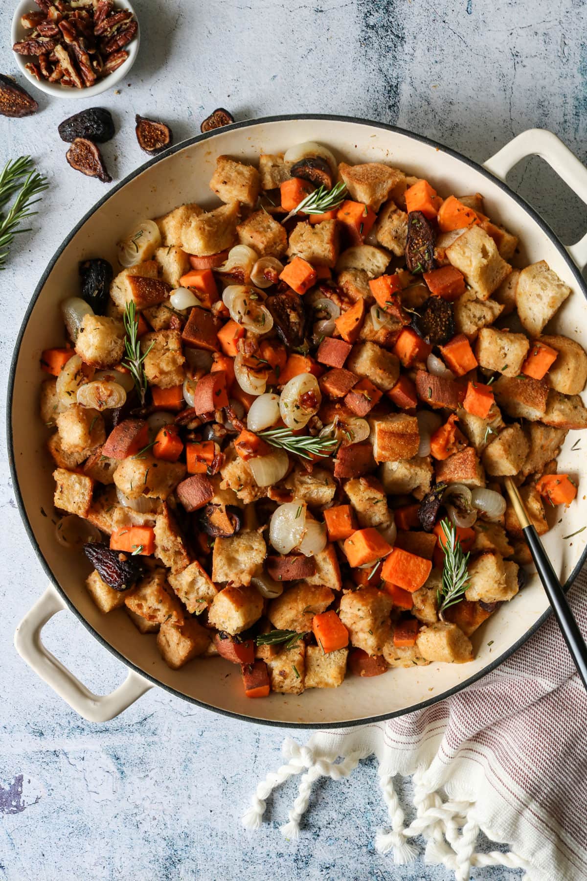 Sweet Potato, Fig, and Rosemary Stuffing in a dutch over with fresh rosemary.