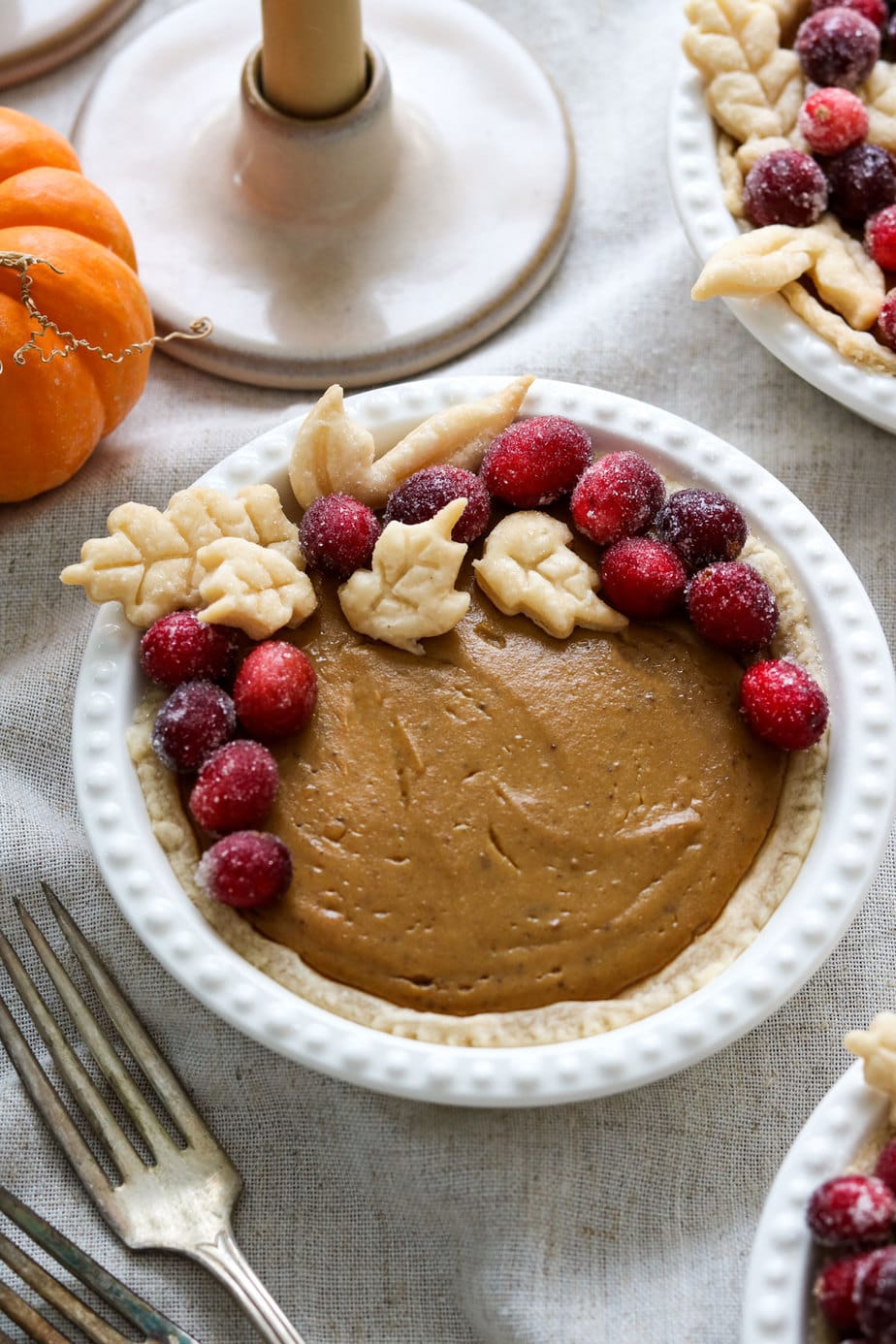 mini vegan pumpkin pies on a thanksgiving table. 